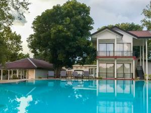 a house with a swimming pool in front of a house at The Lion Kingdom Sigiriya in Sigiriya