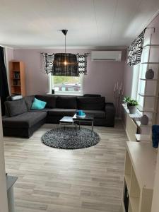 a living room with a couch and a table at 30 min from Northvolt/5 min from Boliden in Boliden