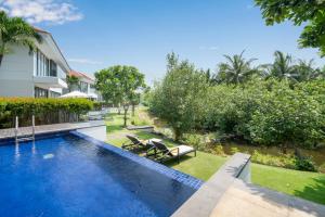 a swimming pool in the backyard of a house at Blue Sky & Villas Beach Resort in Da Nang