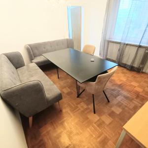 a living room with a table and a couch at FMI9Accomation Raunheim in Raunheim
