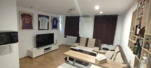 a living room with a couch and a tv at Mokusnice in Zenica