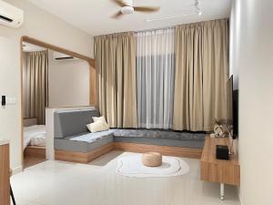 a living room with a couch in front of a window at Nordic Minimalist Kajang Getaway in Kajang +26 photos