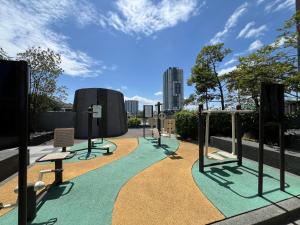 a playground in a park with a green path at Nordic Minimalist Kajang Getaway in Kajang