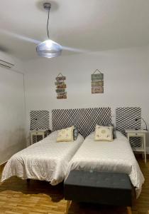 a room with two beds and two tables at Sol y Luna "Desayuno Incluido" in Manzaneque