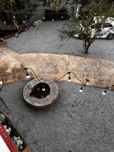 a tire sitting on the ground next to a log at Garden Homestay in Di Linh