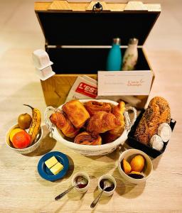 a table topped with three baskets of pastries and desserts at L'Orée des Champs in Lérouville