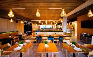 a restaurant with wooden tables and chairs and a bar at Residence Trafick in Prague