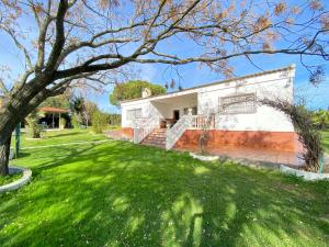 a house with a green lawn in front of it at VILLA LÚA in Cartaya