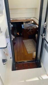 ajar view of a room with a door open to a bedroom at Yacht y fiestas in Barcelona