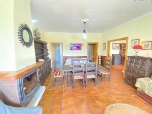 a living room with a table and a fireplace at VILLA LÚA in Cartaya