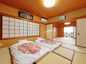 Postel nebo postele na pokoji v ubytování 貸別荘しらゆり