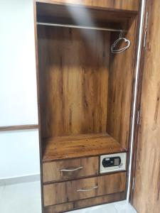 a wooden cabinet with a microwave in it at zoz Chandigarh in Chandīgarh