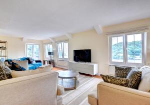 a living room with two couches and a tv at Riversea Cottage in Dartmouth