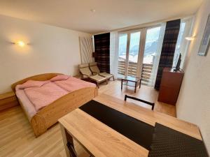 a bedroom with a bed and a table in a room at Matterhof in Leukerbad +37 photos