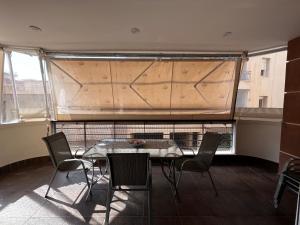 a table and chairs in a room with a large window at Premium Apartment In Chalkida in Chalkida