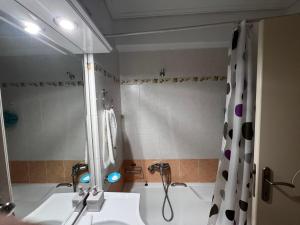 a bathroom with a shower and a white sink at Premium Apartment In Chalkida in Chalkida