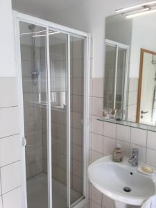 a bathroom with a shower and a sink at Meine Ferienwohnung in Fehmarn