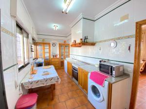 a kitchen with a sink and a microwave at VILLA LÚA in Cartaya