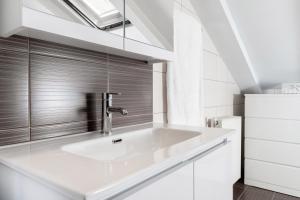 a white sink in a white kitchen with a window at Dimar Apartments in Olympiada
