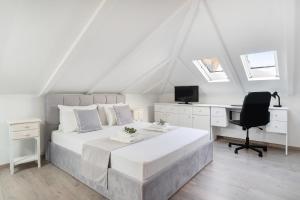 a bedroom with a bed and a desk and a computer at Dimar Apartments in Olympiada