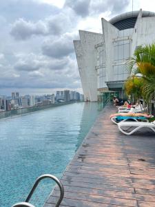 a swimming pool on the roof of a building at Regalia Spritz Empire Hostel in Kuala Lumpur