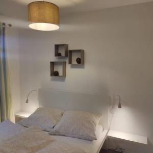 a bedroom with a bed and two shelves on the wall at FeWo Hope in Lindwedel