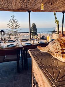 a restaurant with a table with a view of the ocean at Atlas surf in Tamraght Ouzdar