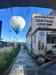 a hot air balloon is flying over a building at Heritage Cave Inn Hotel in Avanos