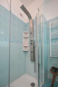 a bathroom with a shower with blue tiles at Nuvola Apartment Fiumicino Easy Self check-in in Fiumicino