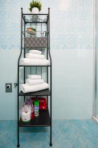 a black towel rack in a bathroom with towels at Nuvola Apartment Fiumicino Easy Self check-in in Fiumicino