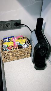 a basket of snacks next to a to printer at Britannia ShortStay Apartment Caransebes in Caransebeş