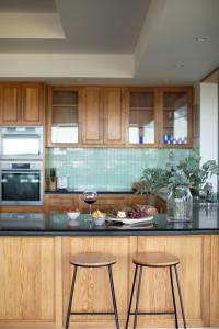 a kitchen with two stools and a counter top at Sea View Guest House in Hobart