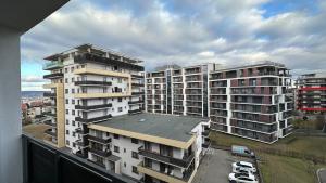 a group of tall buildings in a city at Bonjour Residence with terrace and parking in Cluj-Napoca