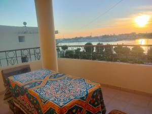 a balcony with a table and a view of the water at Top View in Luxor
