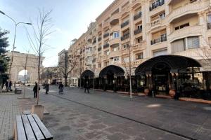 a city street with a building and a bench at Main Square Heaven in Skopje