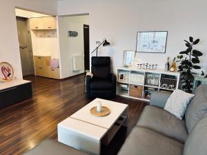 a living room with a couch and a table at Bonjour Residence with terrace and parking in Cluj-Napoca