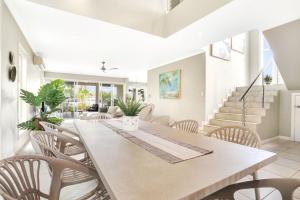 a dining room with a table and chairs at The Anchorage - Ultimate Waterfront Villa in Yorkeys Knob