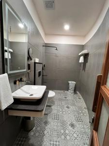 a bathroom with a sink and a shower at Neelam Foresteria Resort in Pachmarhī