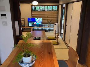 Imakumano Terrace - Eisen An 潁川庵 في كيوتو: مكتب به طاولة عليها نباتات الفخار