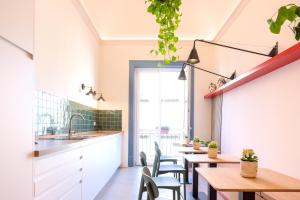 a kitchen and dining room with tables and chairs at Le Dame di Sicilia Sicilian Vintage Rooms in Palermo