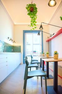 a kitchen with a table and chairs and a counter at Le Dame di Sicilia Sicilian Vintage Rooms in Palermo