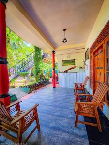 a group of chairs sitting on a porch at Green Star Safari Home in Udawalawe