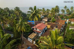 an aerial view of a resort with palm trees and the ocean at Ekostay - OCEAN CREST VILLA I 50 meters from Anjuna Beach in Vagator