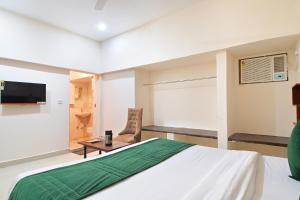 a bedroom with a large bed and a television at Chowdhry Tourist Lodge - New Delhi Railway Station - 2 minutes walk in New Delhi