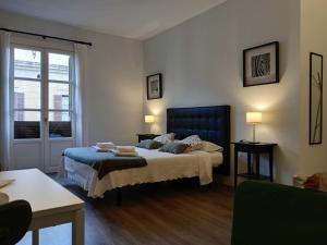- une chambre avec un lit doté d'une tête de lit bleue dans l'établissement Colom Apartments, à Barcelone