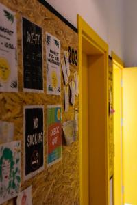 a wall with posters and signs on it at Limon Inn Hotel, Taşucu in Tasucu