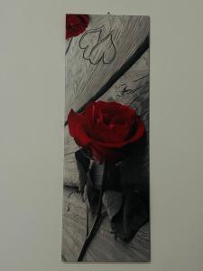 a picture of a red rose on a wooden floor at APPARTAMENTO Exclusive in Marsala
