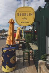 a sign for a restaurant with a table and chairs at Limon Inn Hotel, Taşucu in Tasucu