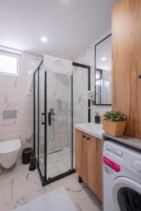 a bathroom with a shower and a washing machine at Verde Mare Hotels in Antalya