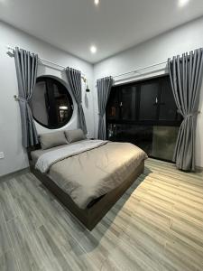 a bedroom with a large bed with a large window at Relax Homestay - Đảo Phú Quý in Cu Lao Thu